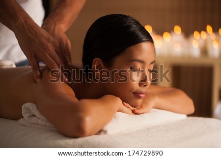 Young Thai woman enjoying a relaxing back massage.