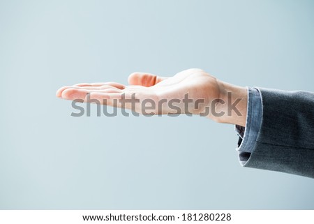 Close-up of a businessman\'s hand palm up.