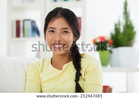Indoor portrait of a smiling young Asian woman.