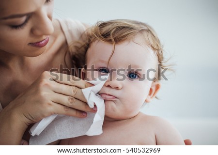 Mother Wiping Baby\'s Face