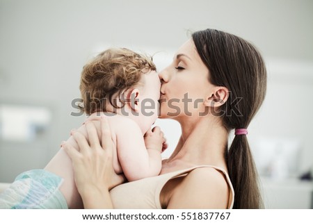 Loving mother kissing her baby boy.