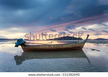 sunlight local life boat Thai fishing boat used as a vehicle for finding fish in the sea.at sunset