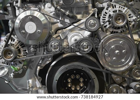 Close up view on new truck diesel engine motor belt, pulleys, gears, alternator and other engine equipment. Assembled truck diesel engine. Abstract auto automotive industrial background pattern