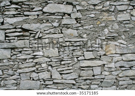 White stone wall, big pieces of stone, all paint white.