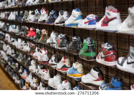 New York, NY, USA - November 9, 2014: Sneakers and sport shoes on the wall in one of the store on the Brodway St., Manhattan.