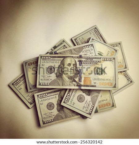 Creative business finance making money concept / Vintage retro effect filtered hipster style image of background of new 100 (hundred) US dollars banknotes (bills) bundles close up - instagram effect