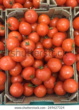 Farmers market tomato in a cardboard fruit crates