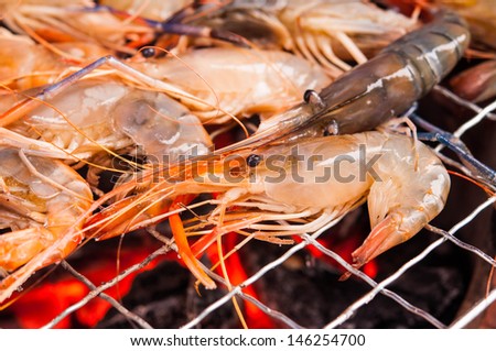 grilled prawns on flaming grill