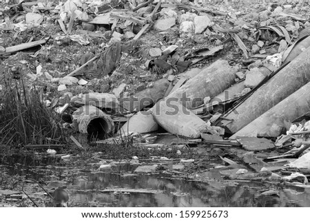 black and white photo of waste pipe or drainage polluting environment, concrete pipe.