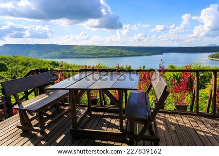 wood table and chair on balcony lake view in Lam Takong Dam, Thailand