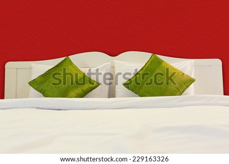 christmas bedroom with White bed and green pillows in red room