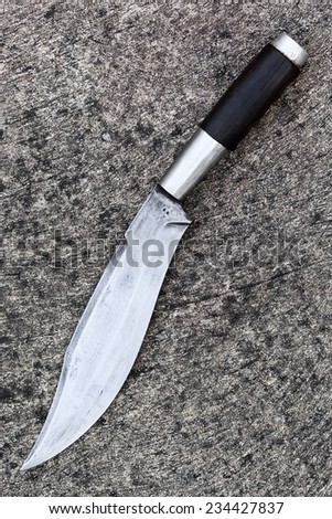 Thai hunting knife on grunge cement background