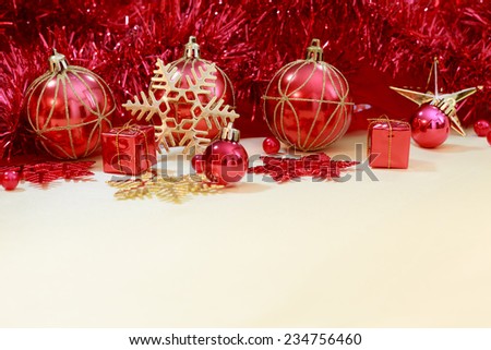 red christmas ornament with gift, ribbon on gold twinkle paper background