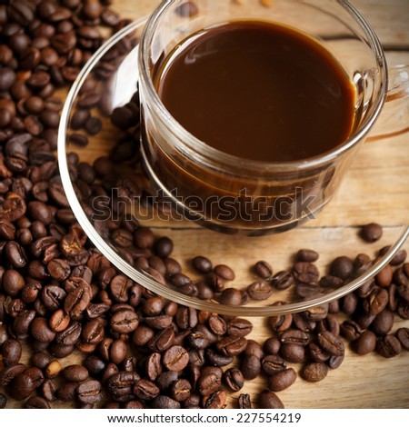 coffee with coffee beans, brown sugar on wooden table