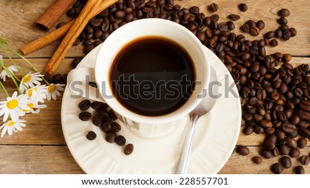 coffee with coffee beans, brown sugar on wooden table
