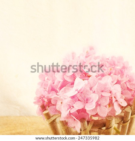 Sweet Pink Hydrangeas in basket on mulberry paper texture