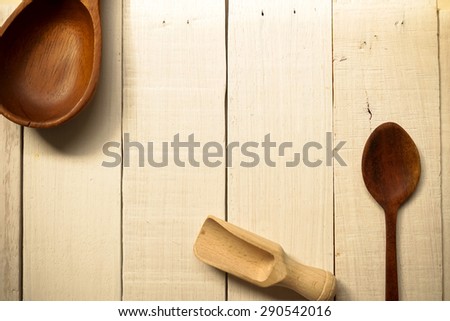 Wooden scoop and spoons on white wooden table, kitchen tool background