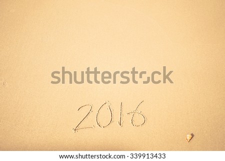 2016 text on the beach for new year concept background