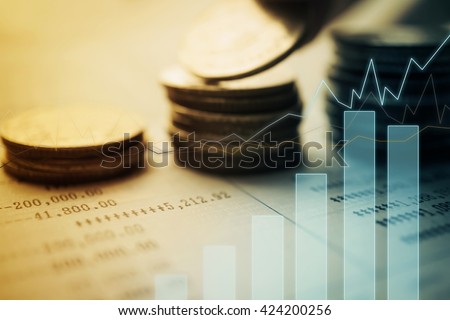Double exposure of graph and rows of coins for finance and banking concept
