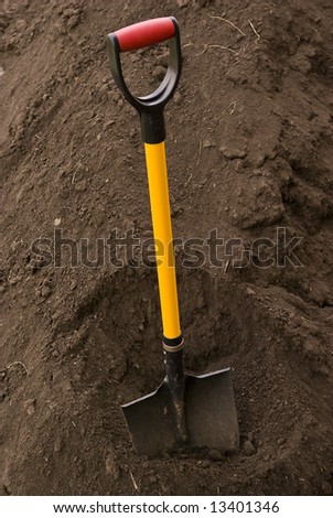 Spade putted into heap of ground