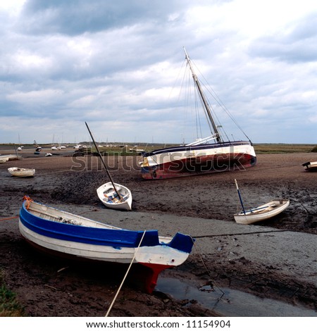 Boats left on the bed of an estuary after the tide has gone out