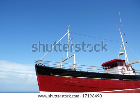 Bright red fishing boat at sea