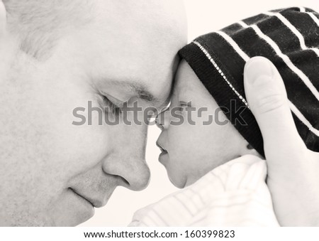 happy father with newborn son on a white background