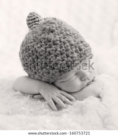 sweet newborn baby sleeping with  hat ( black and white )