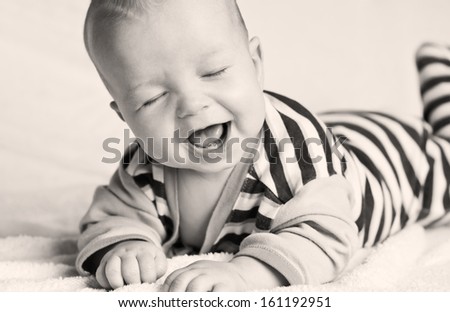 Happy little baby laughing with eyes closed (black and white)