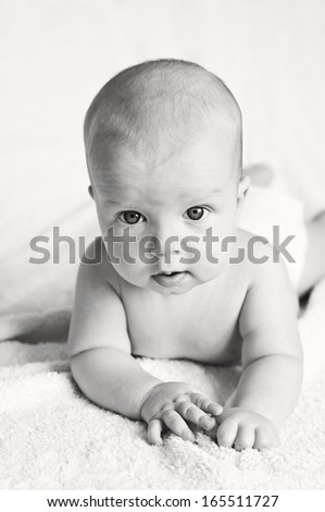 cute blue-eyed baby looking at the camera on a white background ( black-white )