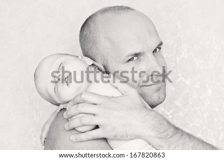 baby asleep on his father\'s shoulder ( black-white )