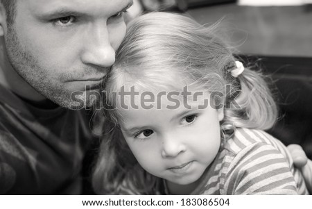 father hugging little daughter calms (black and white)