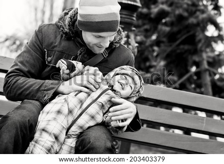 happy father and baby son playing outdoors (black and white)