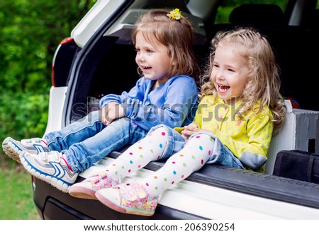 two happy kids in the car