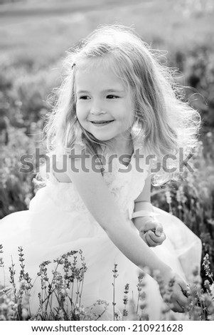 Smiling toddler girl in lavender field ( black and white )