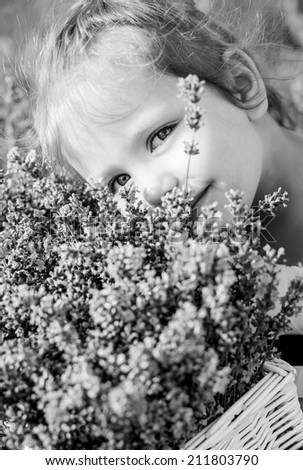 cute little girl smiling in a lavender field  ( black and white )