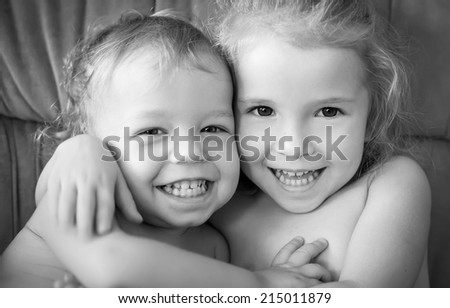 happy little brother and sister hugging ( black and white )