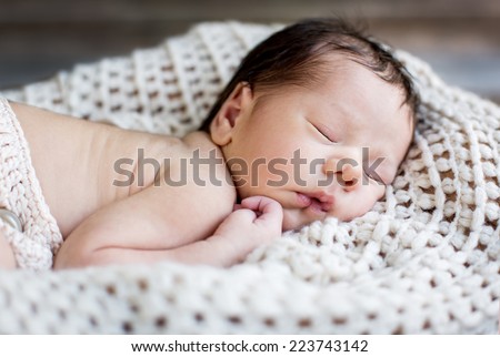 portrait cute newborn baby sleeping to knit a blanket