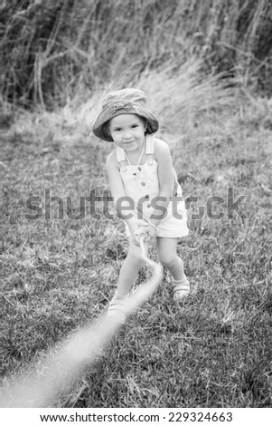 happy little girl playing in nature ( black and white )