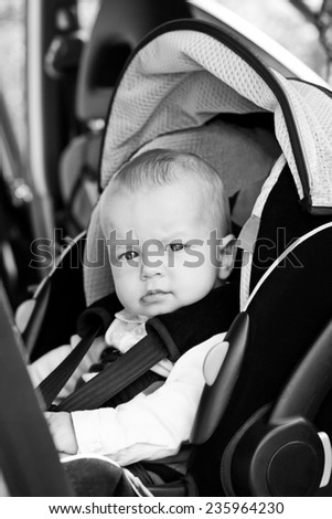 Cute little boy in car seat ( black and white )