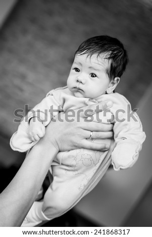 Newborn baby in the arms of his mother ( black and white )