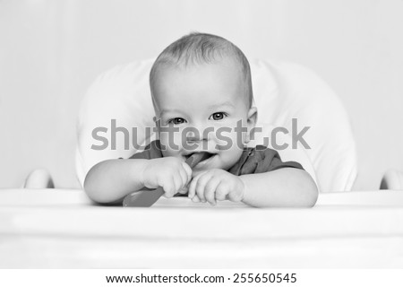 laughing boy holding a spoon on a white background  ( black and white )
