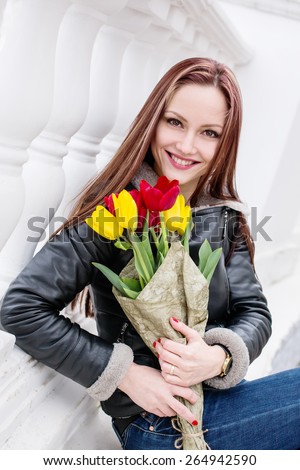 beautiful happy woman with tulips on a white background