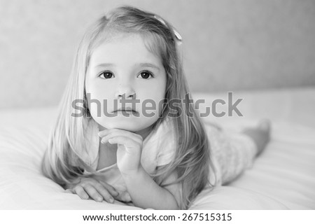 portret adorable little girl waked up in her bed ( black and white )