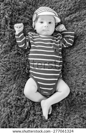 cute newborn baby in knitted cap ( black and white )