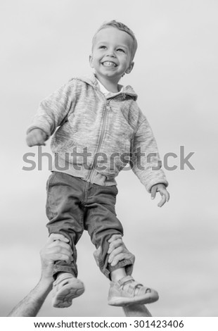 Happy Toddler boy in his father\'s arms  ( black and white )