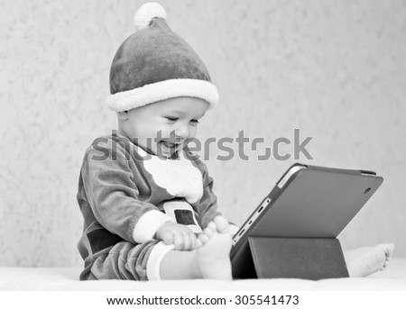 happy santa helper baby boy with digital tablet  ( black and white )
