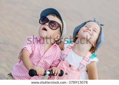 two little happy child play on a sunny day