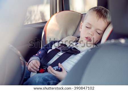 cute little boy sleeping in car seat