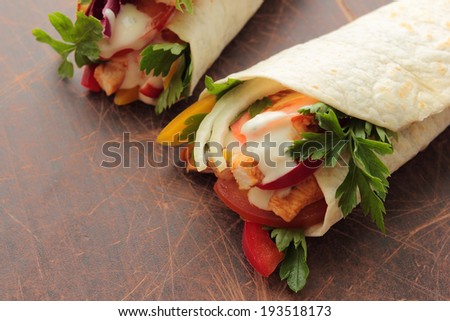 Tortilla wraps with tasty chicken and fresh vegetables